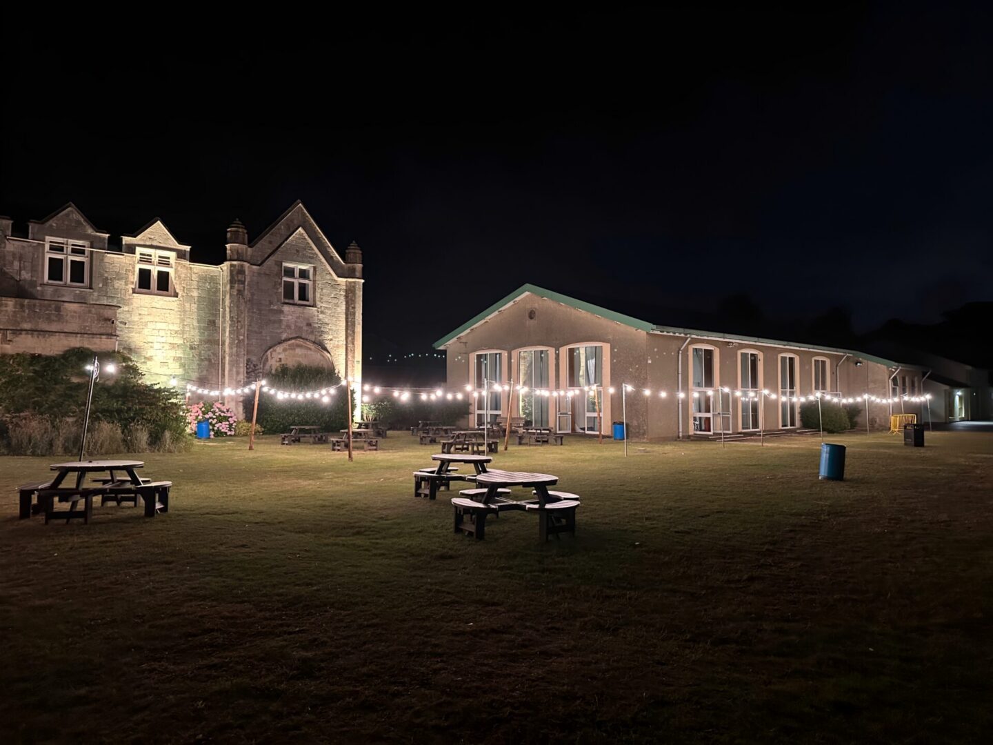 Outdoor area with string lights at night.