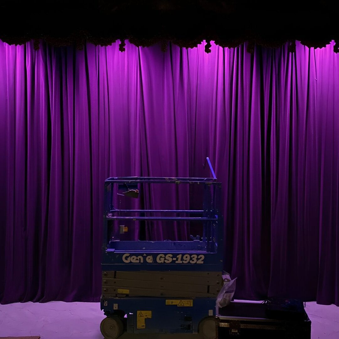 Stage with purple curtains and lift.